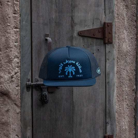 Salalah Surf Club navy foam trucker hat with Omani coastal embroidery, cap by One8