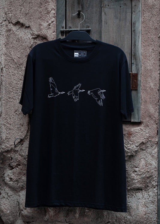 Houbara in Flight Black T-shirt - featuring a حبارى (houbara bustard) designed by Khalid Al Astad