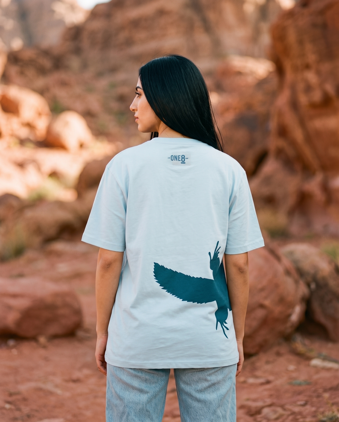 Uromastyx Dhab tee back tail print worn by female model in red rocky desert