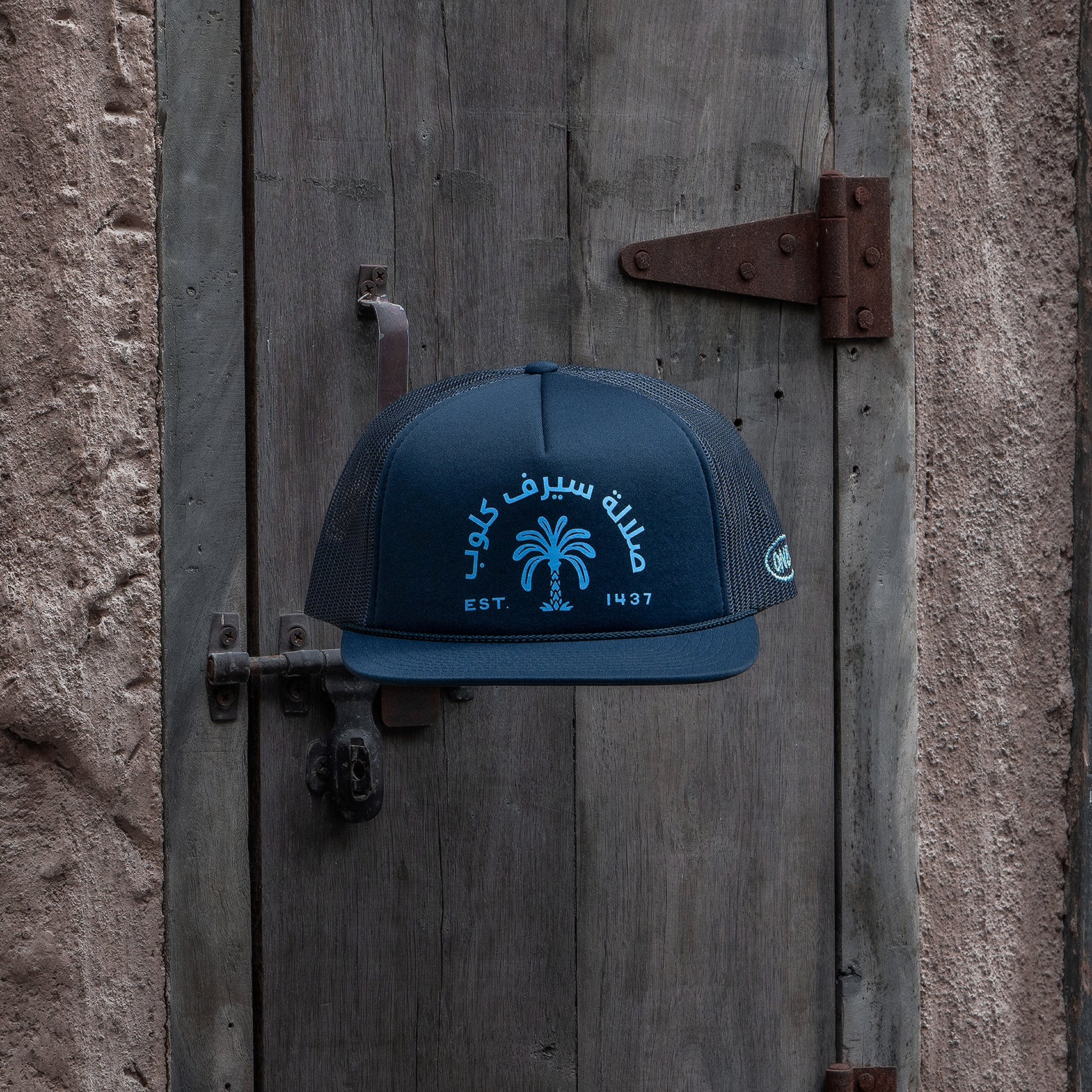 Salalah Surf Club navy foam trucker hat with Omani coastal embroidery, cap by One8