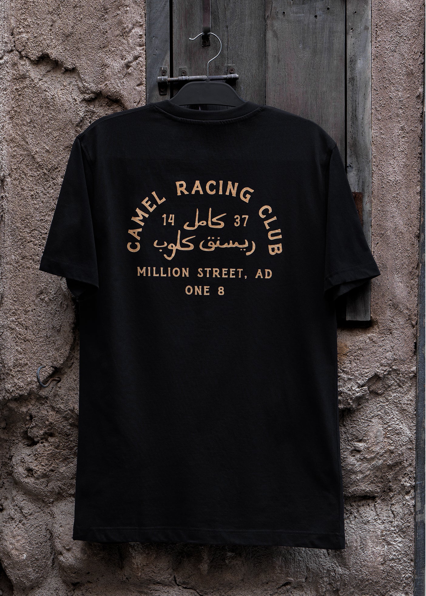 Camel Racing Club Arabic tee with bold Arabic calligraphy, Gulf desert culture streetwear by One8