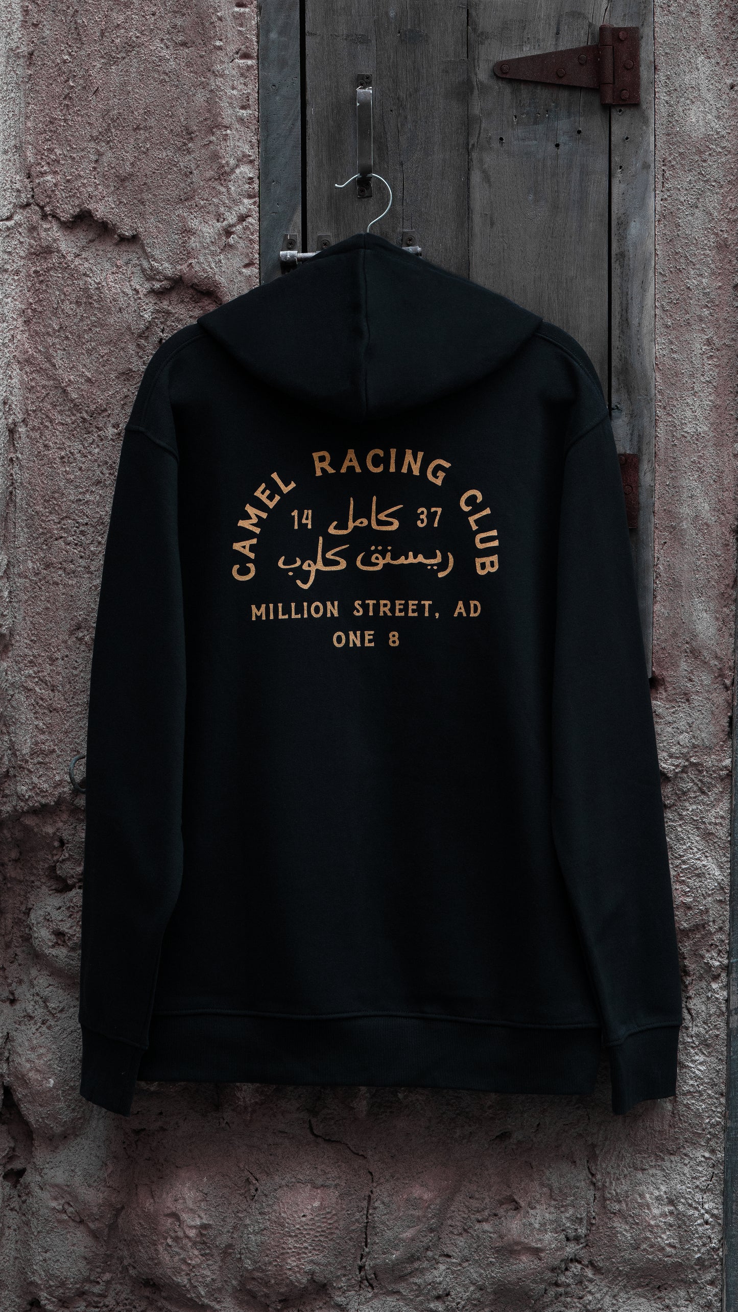 Camel Racing Club Arabic hoodie with bold Arabic calligraphy, Gulf streetwear by One8
