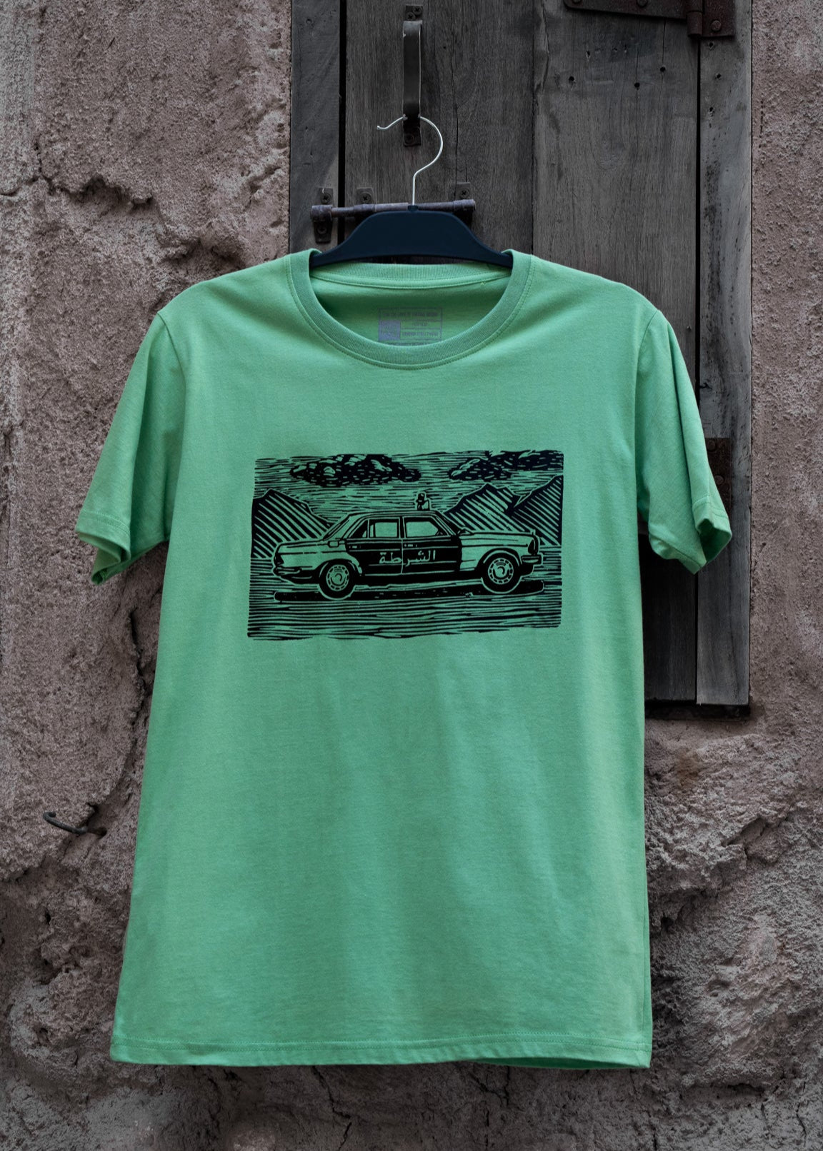 شرطة دبي Dubai Police Green T-shirt with hand drawn linocut design inspired by classic police car