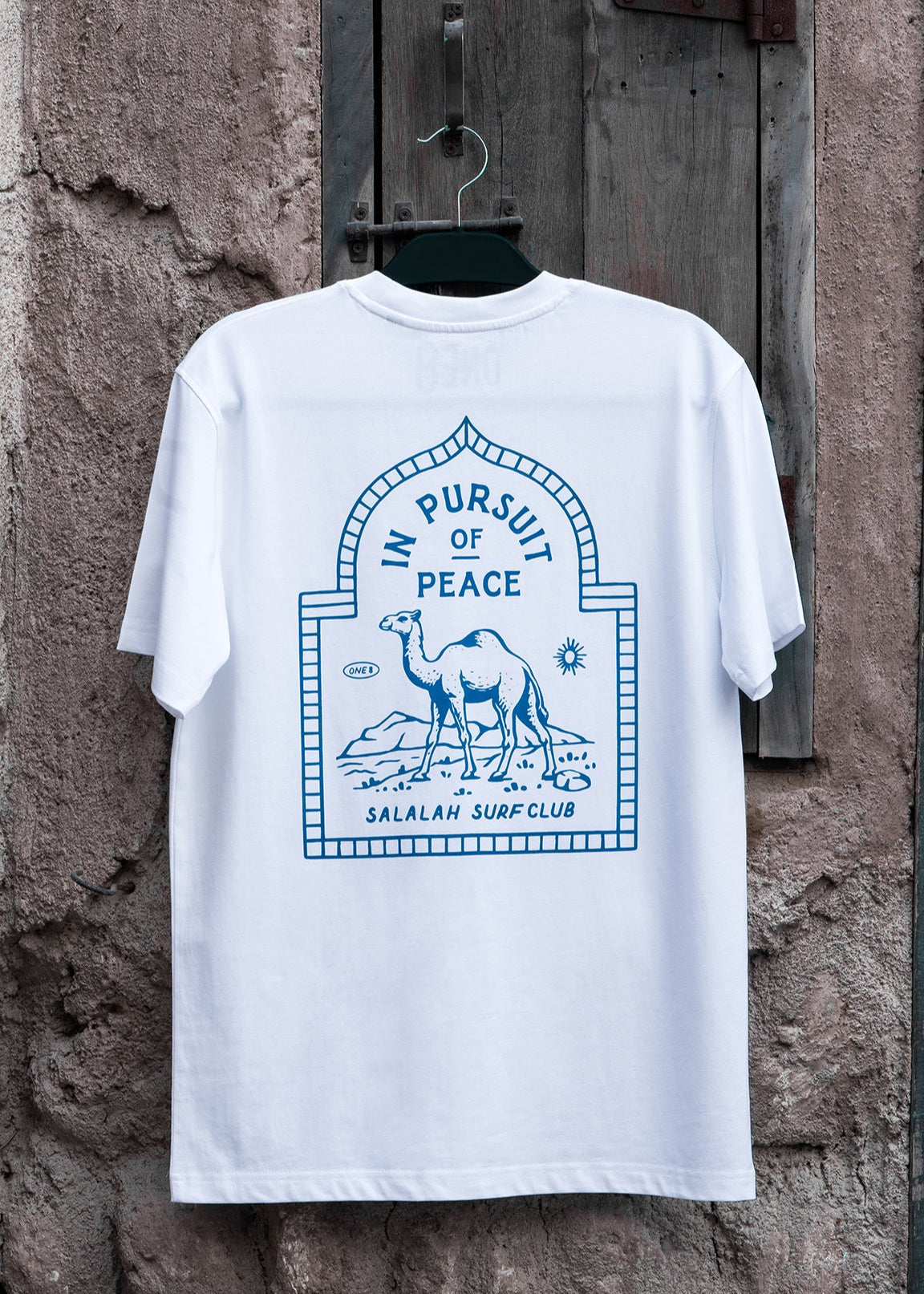 Salalah Surf Club camel tee with hand-drawn camel, Omani culture streetwear by One8