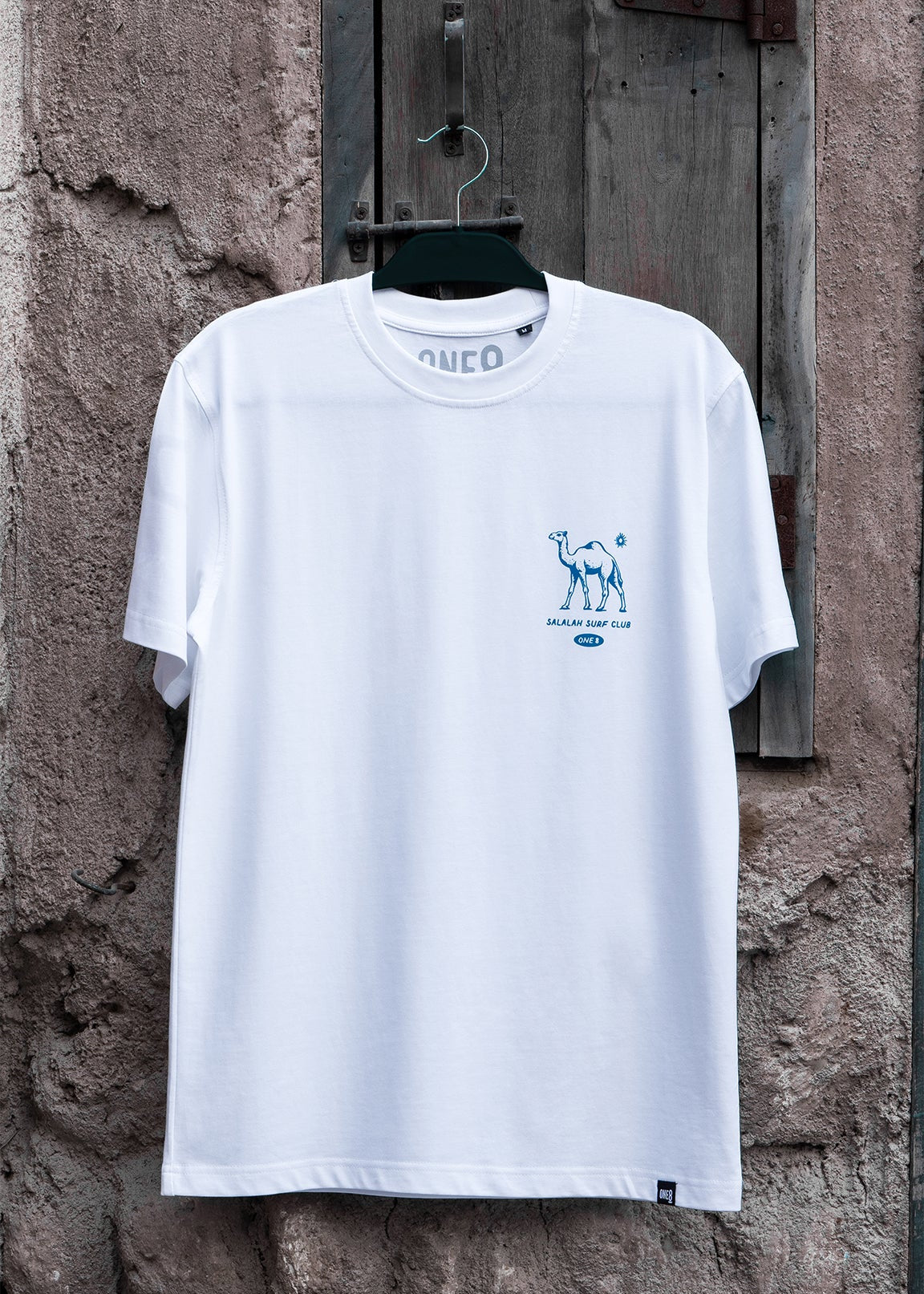 Salalah Surf Club camel tee with hand-drawn camel, Omani culture streetwear by One8