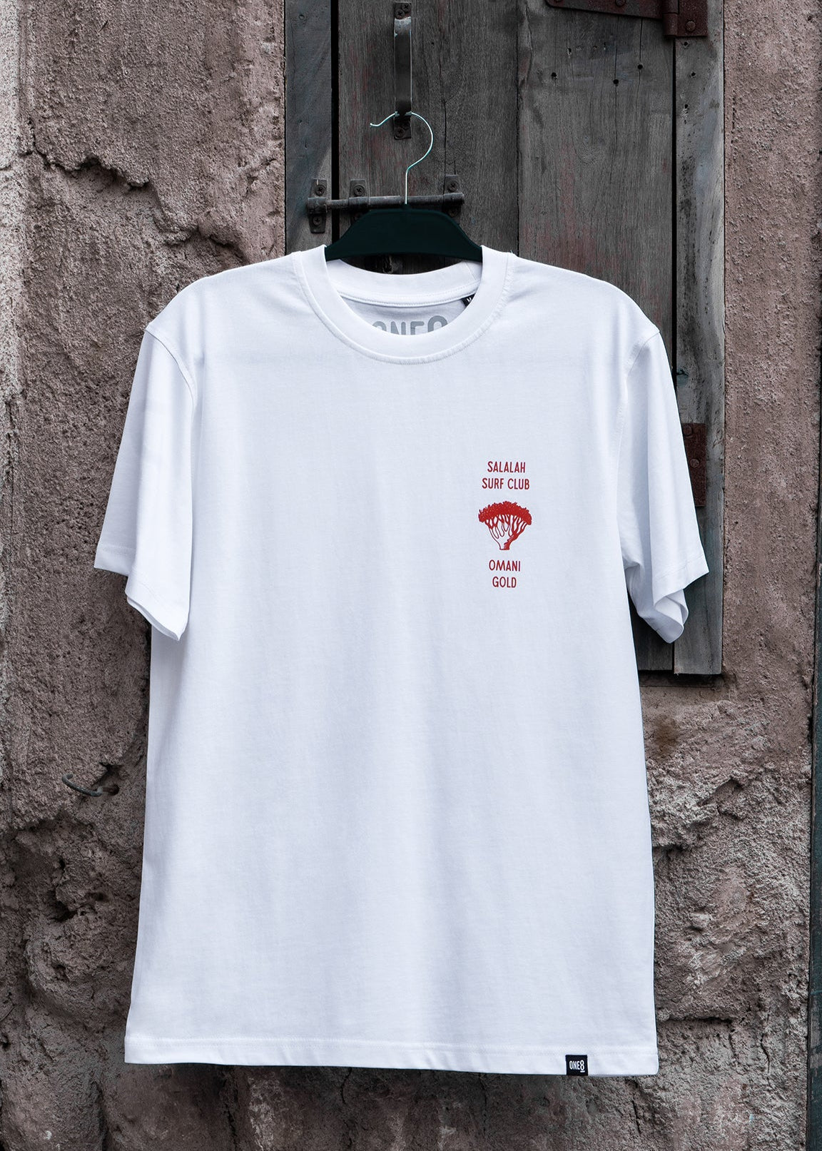 Salalah Surf Club Omani Gold tee with frankincense tree design, Omani culture streetwear by One8