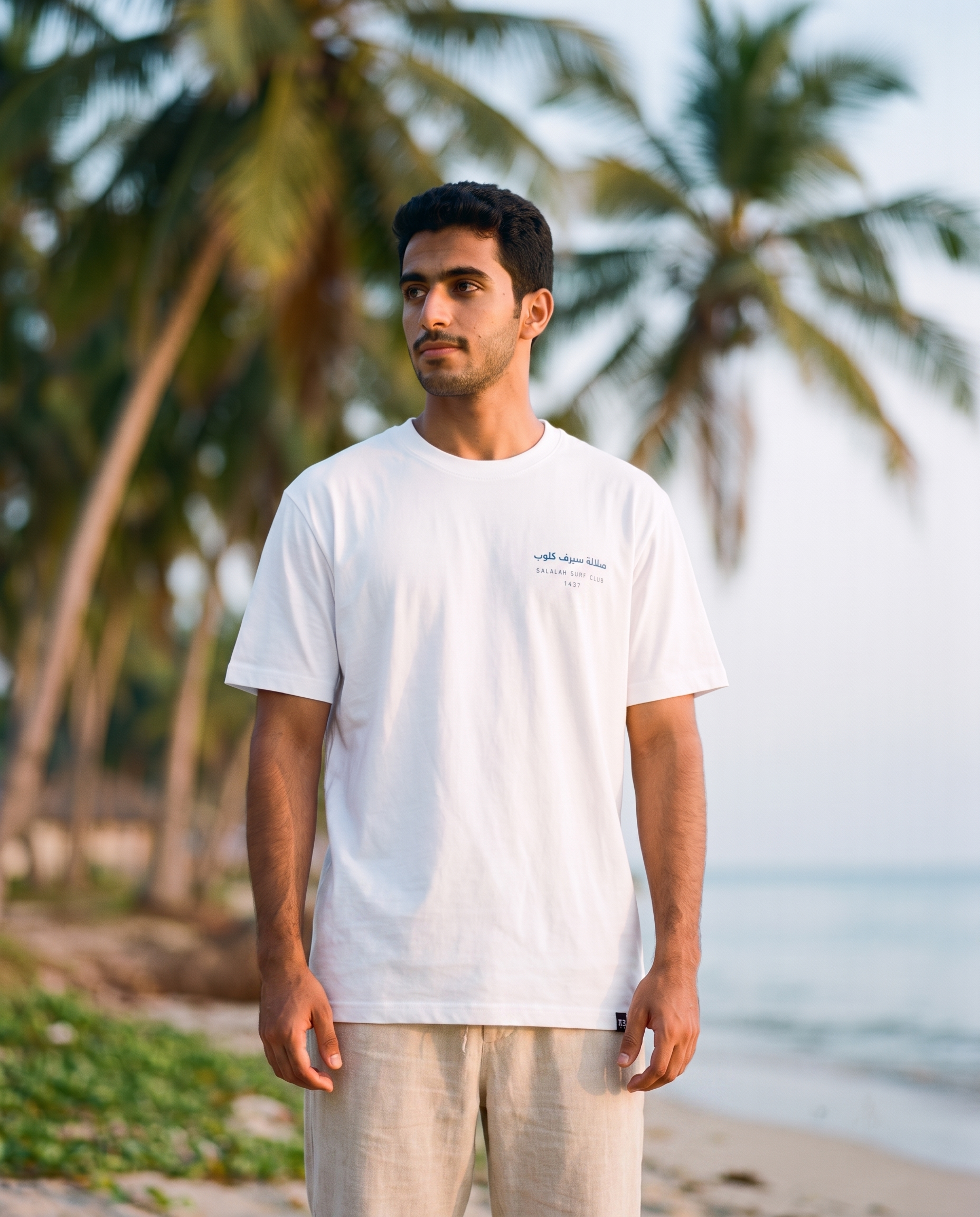 Salalah Surf Club Coconut Palms tee front chest print, male model, oversized fit