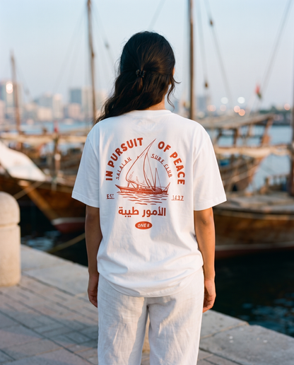 Salalah Surf Club Dhow tee back print worn by female model at Dubai Creek
