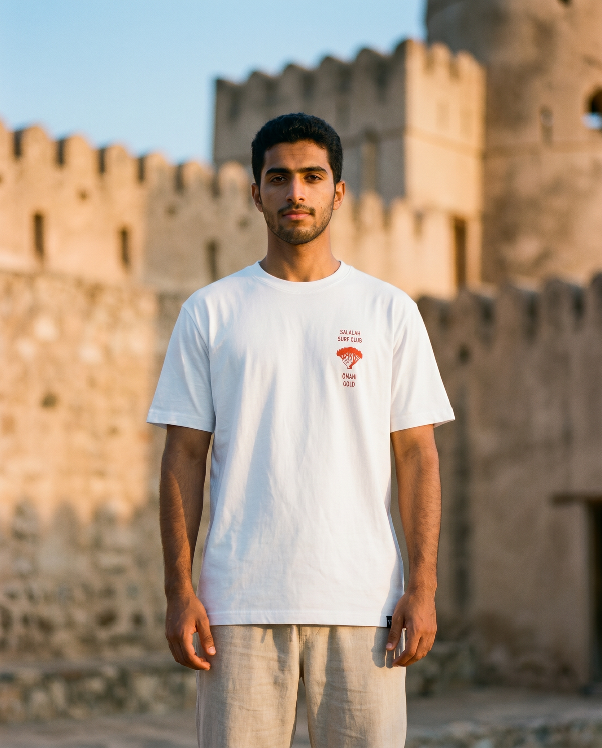 Salalah Surf Club Omani Gold tee front chest print with frankincense tree, male model