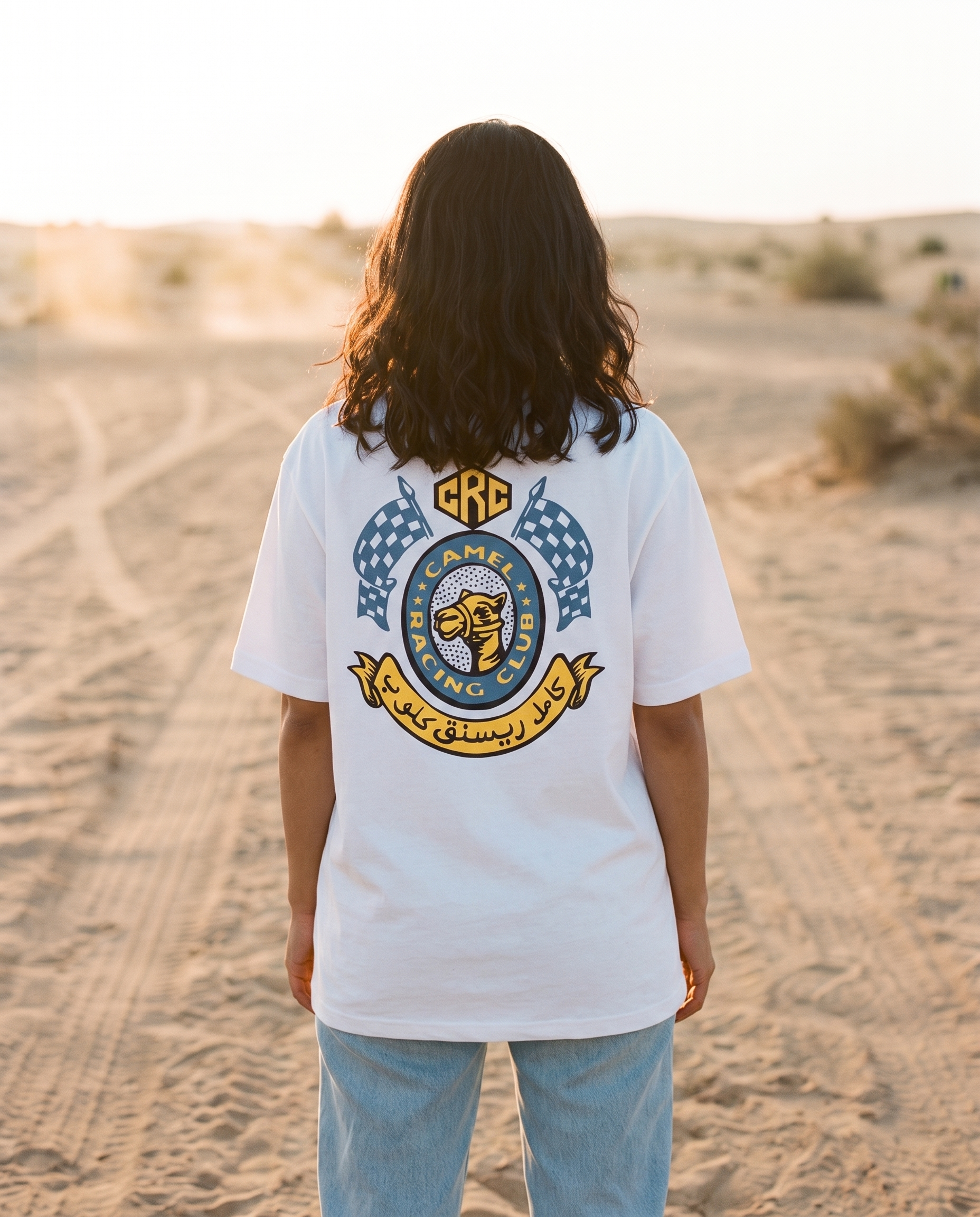 Winner's Circle Camel Racing Club tee back crest print, female model on desert track