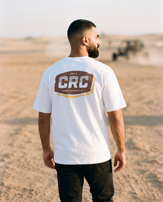 Motocross Camel Racing Club tee CRC badge print, male model walking desert trail