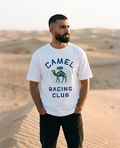 Skeletal Camel Racing Club tee, male model standing on dune crest