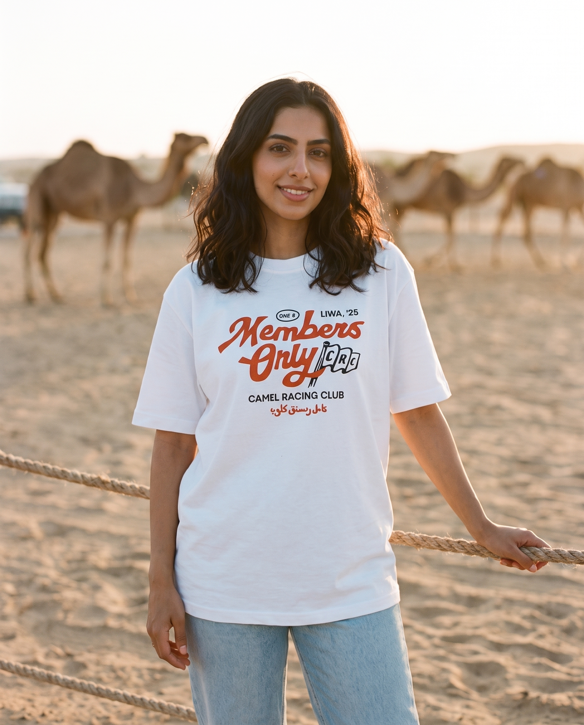 Members Only Camel Racing Club tee, female model at camel paddock with camels