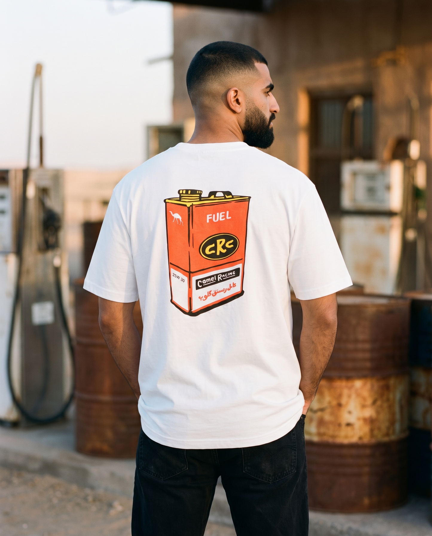 Vintage Fuel Can Camel Racing Club tee back print, male model at old desert petrol station