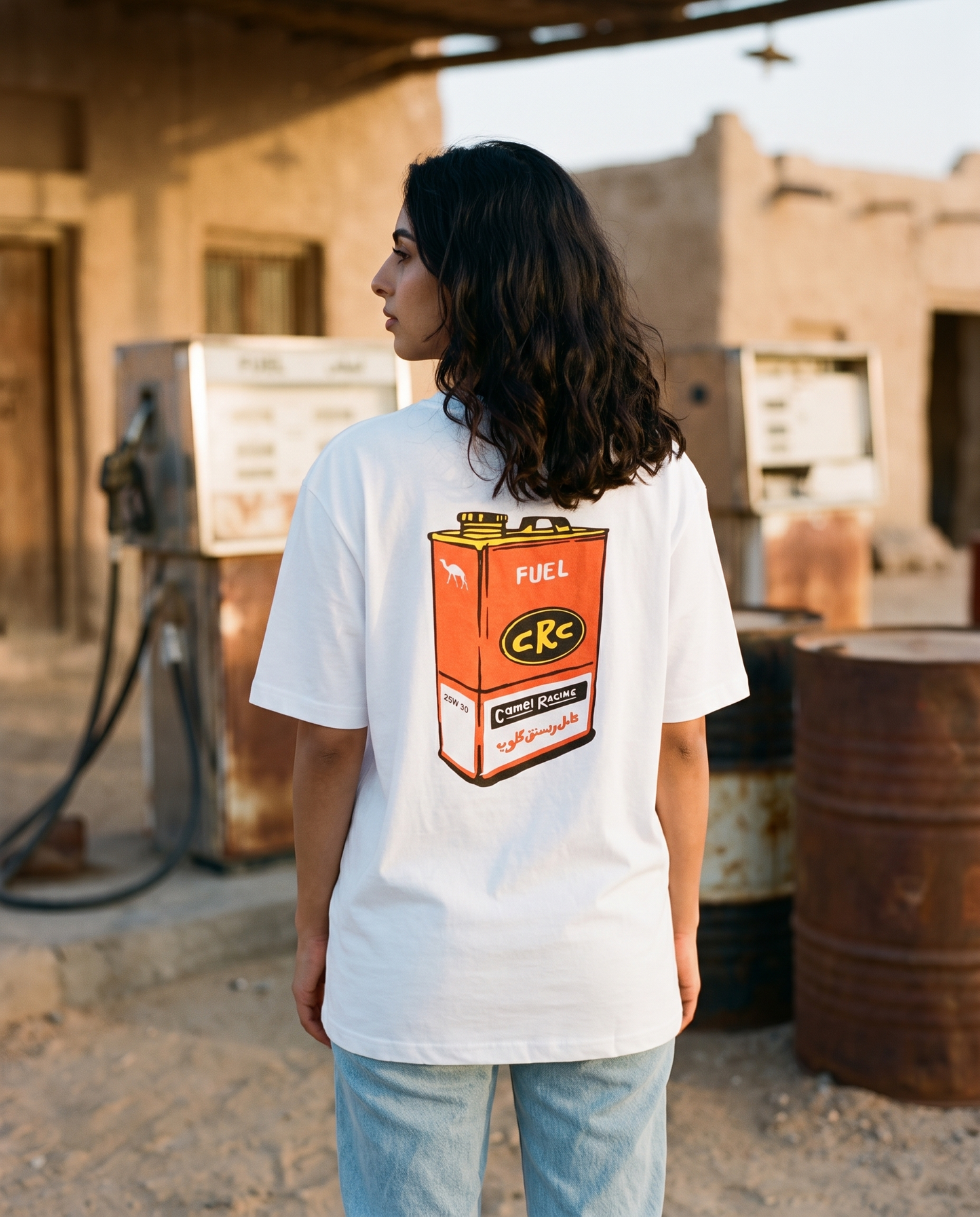 Vintage Fuel Can Camel Racing Club tee back print, female model at old desert petrol station