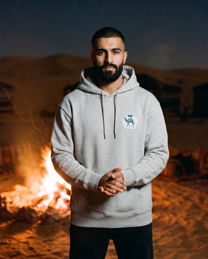 Skeleton camel hoodie in heather grey worn by male model at a desert camp fire at night