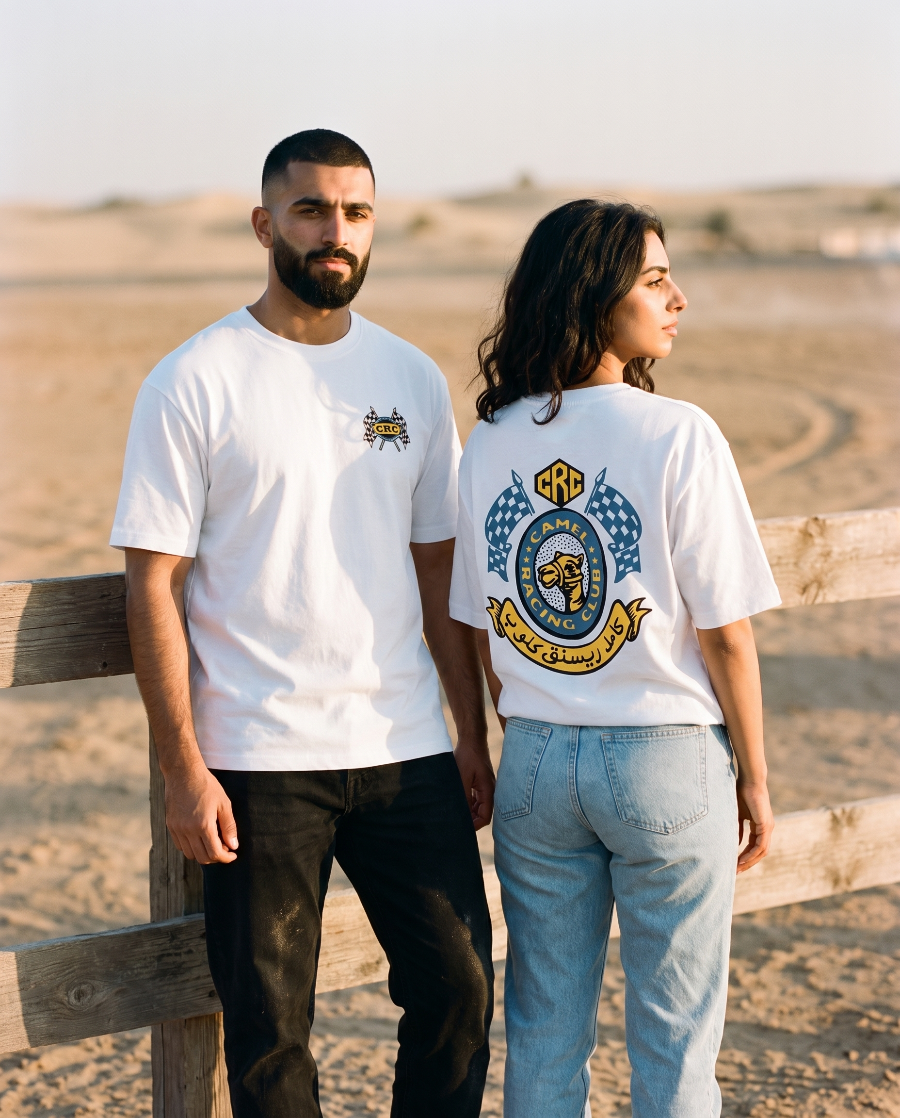 Winner's Circle tee worn by male and female models at a desert race track, front and back view