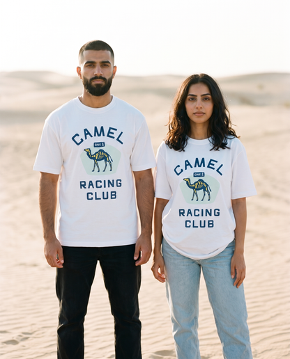 Skeletal camel tee front print worn by male and female models on pale sand dunes