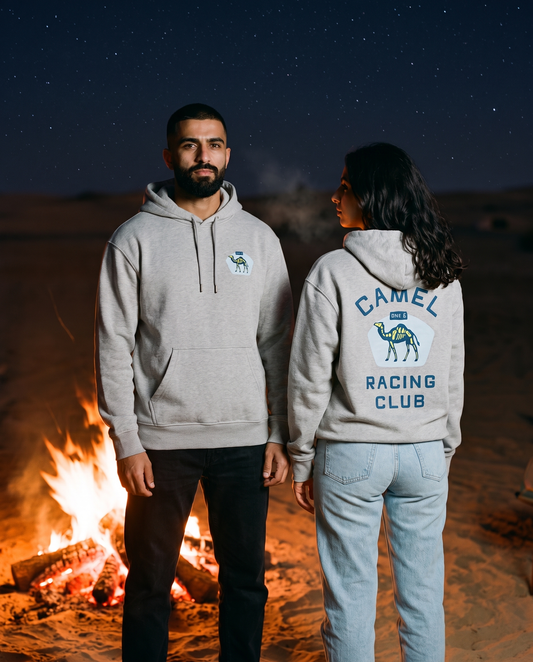 Skeleton camel hoodie in heather grey worn by male and female models at a night desert campfire, front and back view