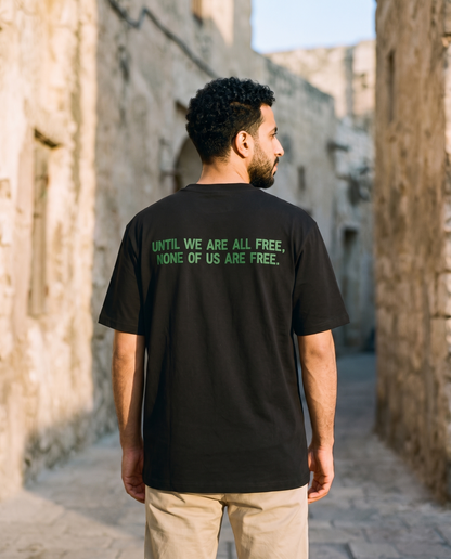 Free Palestine black tee back print worn by male model reading until we are all free none of us are free