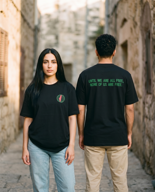 Free Palestine black tee worn by male and female models in an old stone alley, front and back view