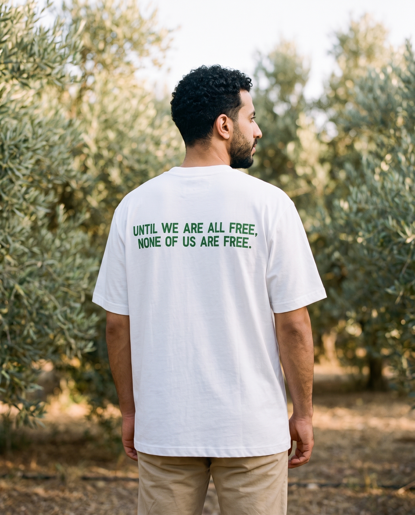 Free Palestine white tee back print worn by male model reading until we are all free none of us are free