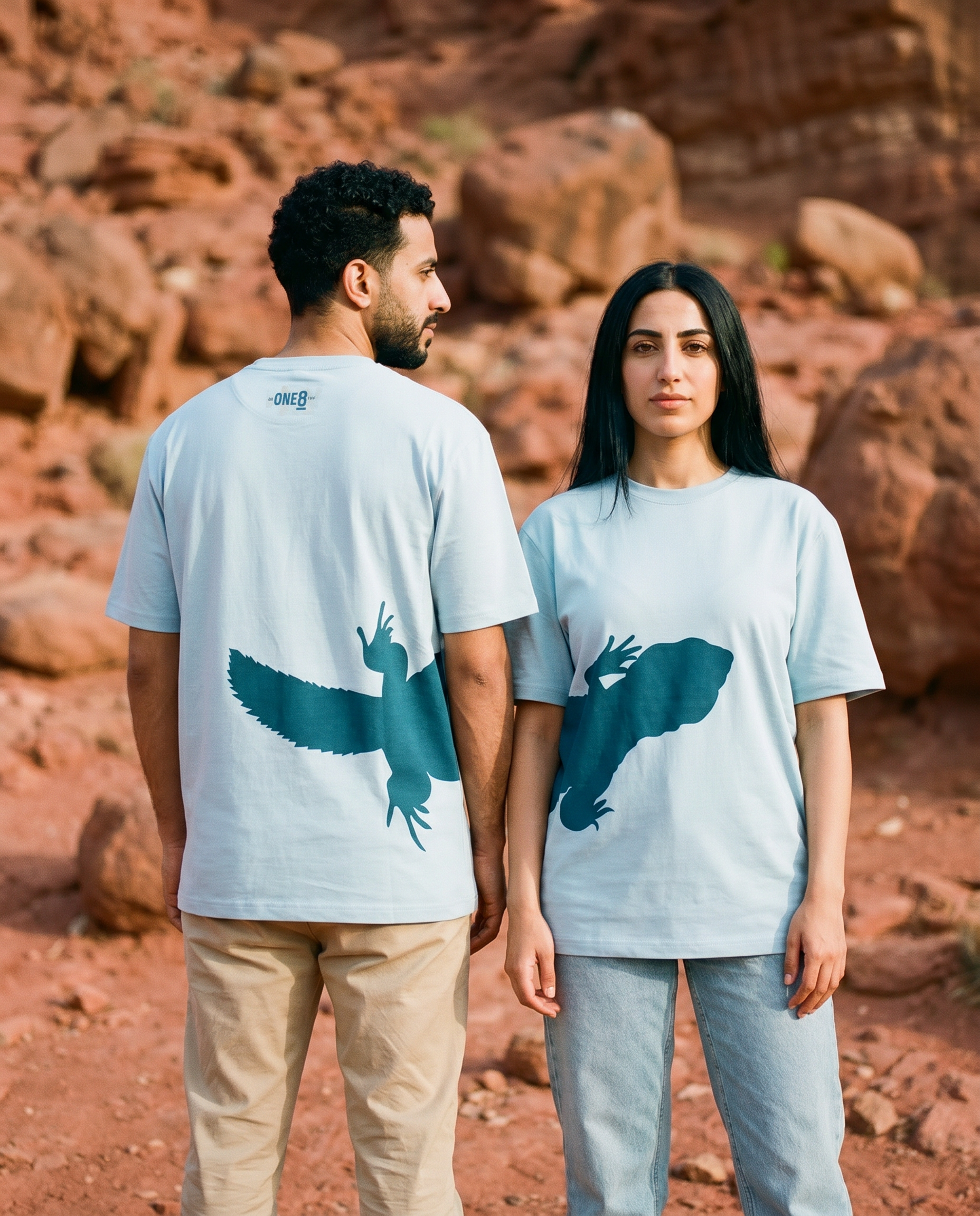 Uromastyx Dhab tee worn by couple with the lizard print lining up across front and back