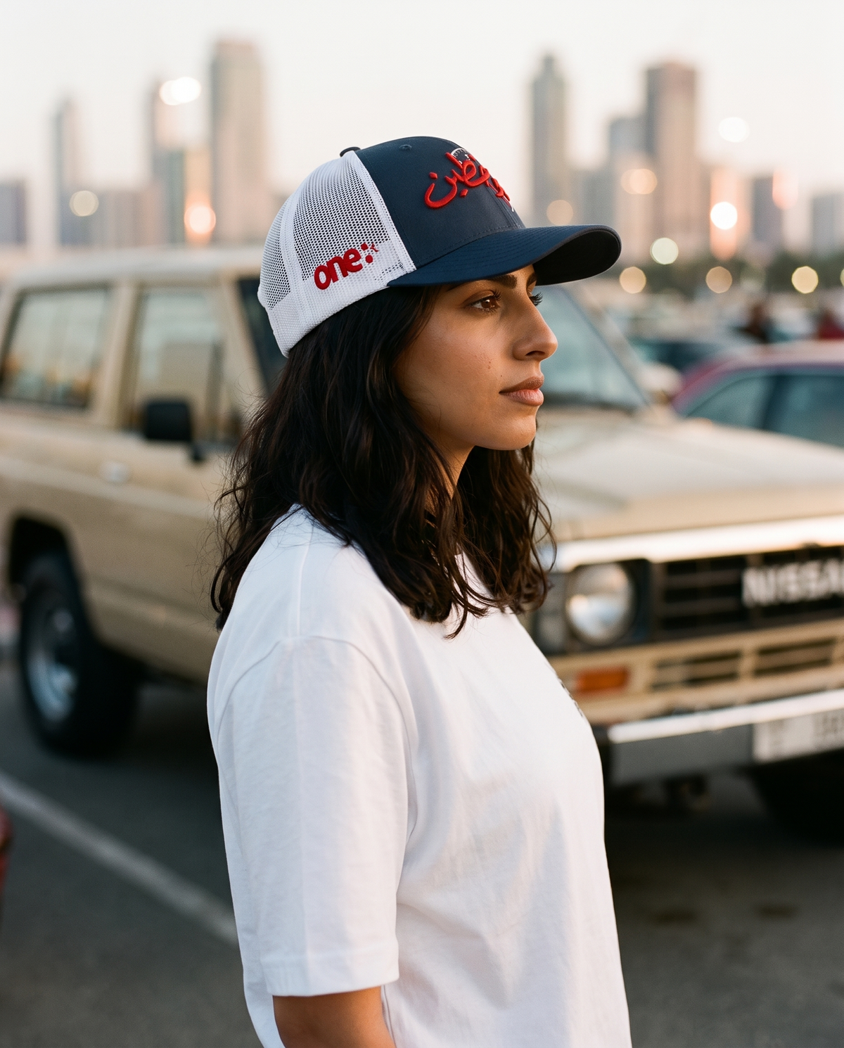 Sitta Wa Khattain trucker hat side profile on female model at a Gulf city car meet