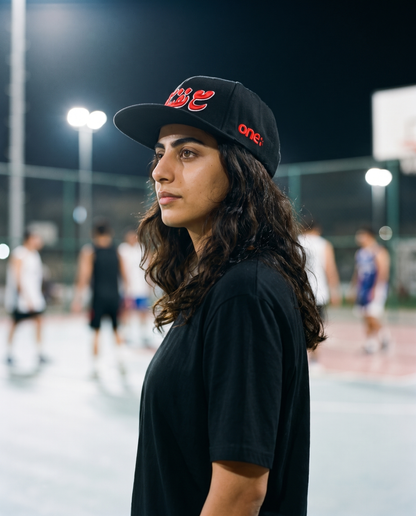 Ma'a Nafsak snapback side profile on female model at streetball court