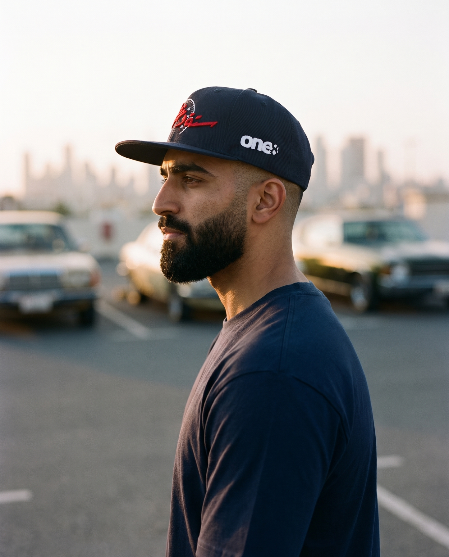 Sitta Wa Khattain snapback side profile on male model with classic cars behind