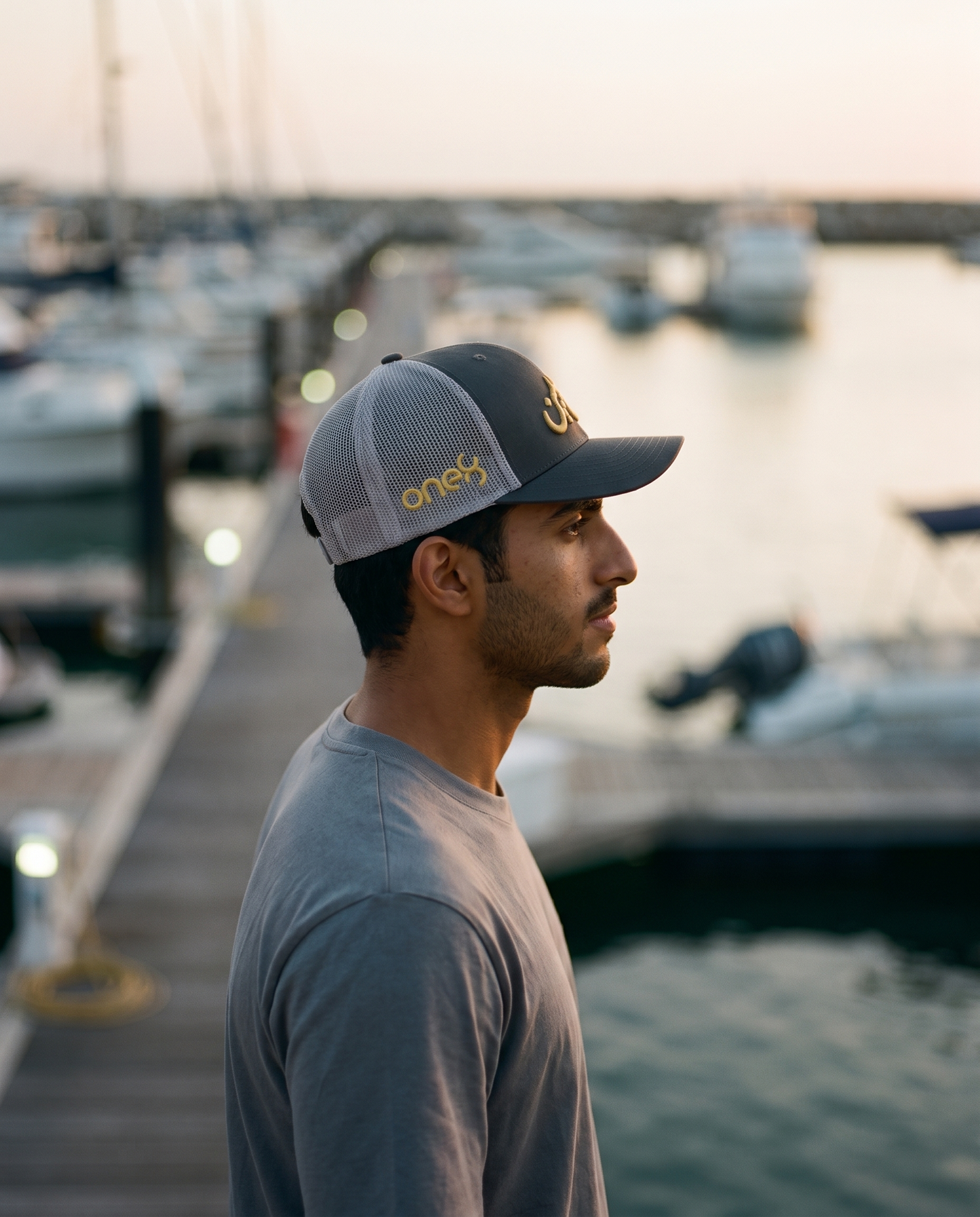 Mal Al Tayyebeen trucker side profile with gold one8 logo at the marina