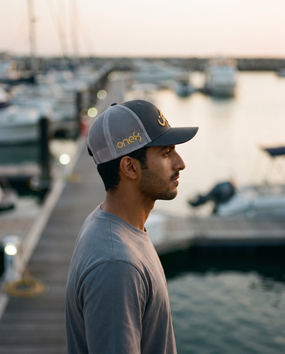 Mal Al Tayyebeen trucker side profile with gold one8 logo at the marina