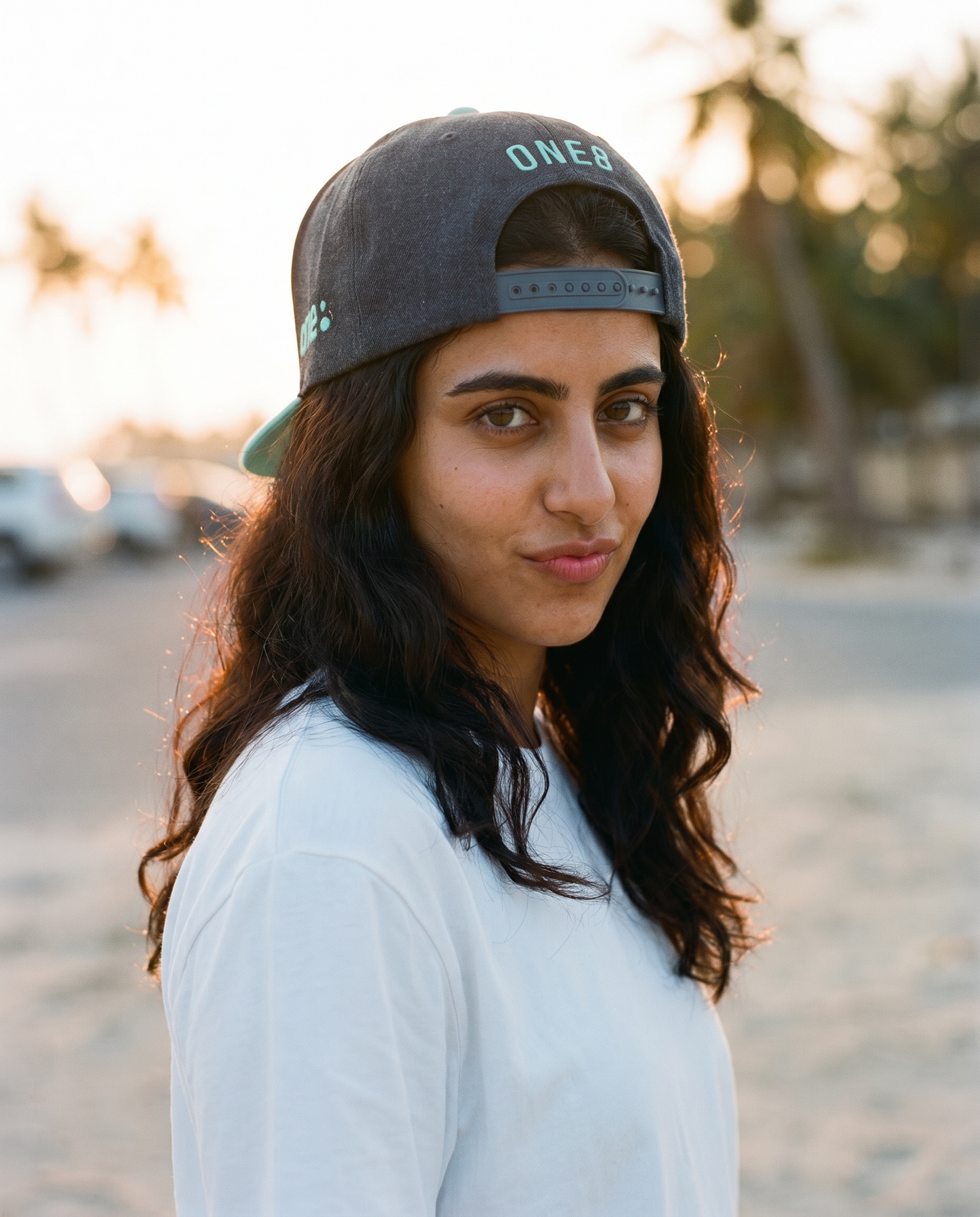 Jumeirah flat brim hat worn backwards showing ONE8 back at the beach