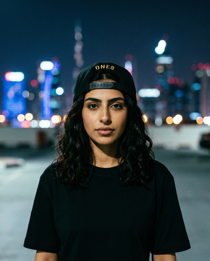 Al Namoos flat brim snapback worn backwards - on model