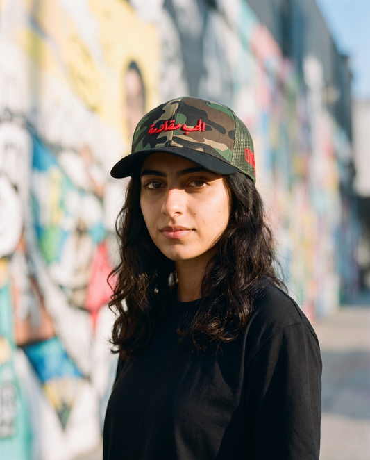 Love is Resistance camo trucker worn frontwards - on model