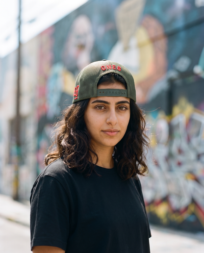 Love is Resistance camo trucker worn backwards - on model