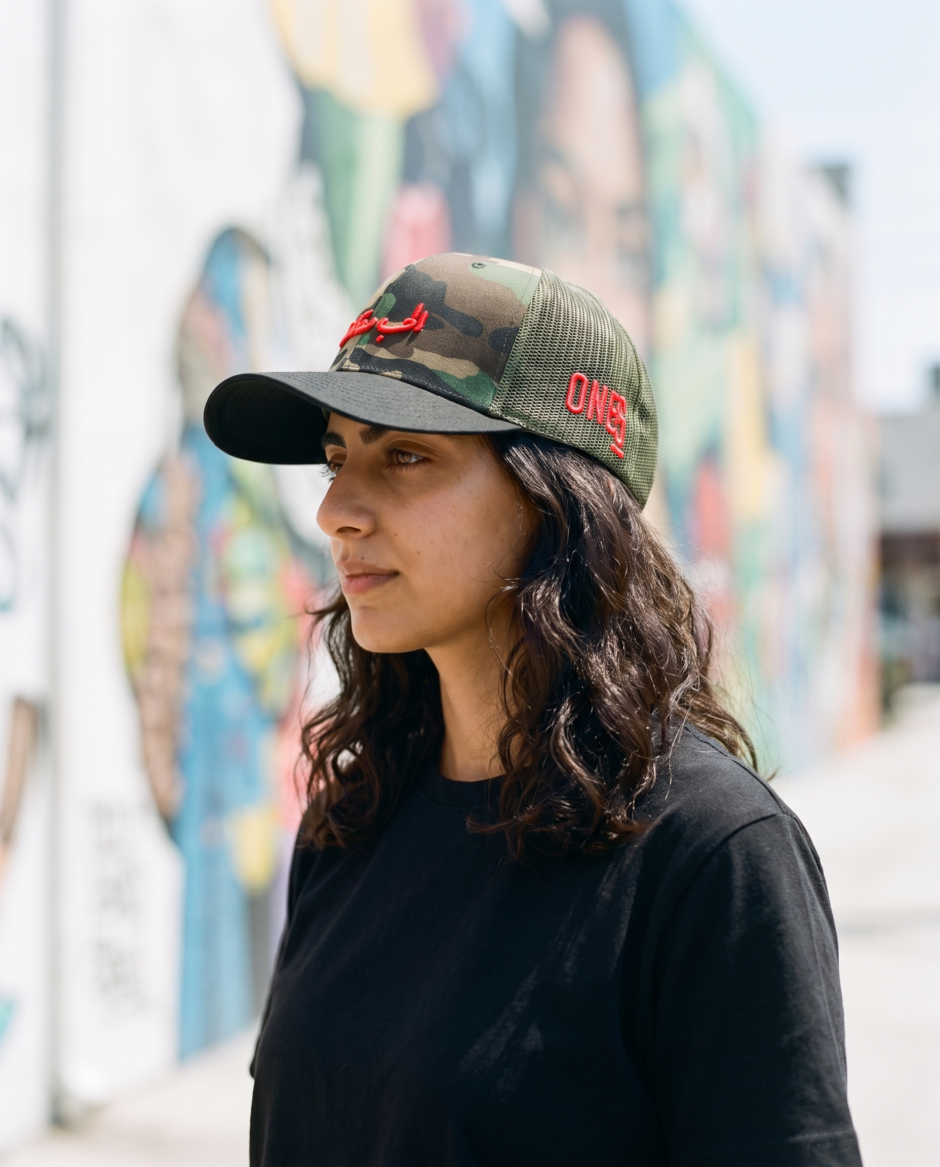 Love is Resistance camo trucker side profile - on model