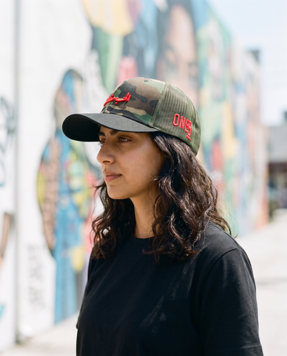 Love is Resistance camo trucker side profile - on model