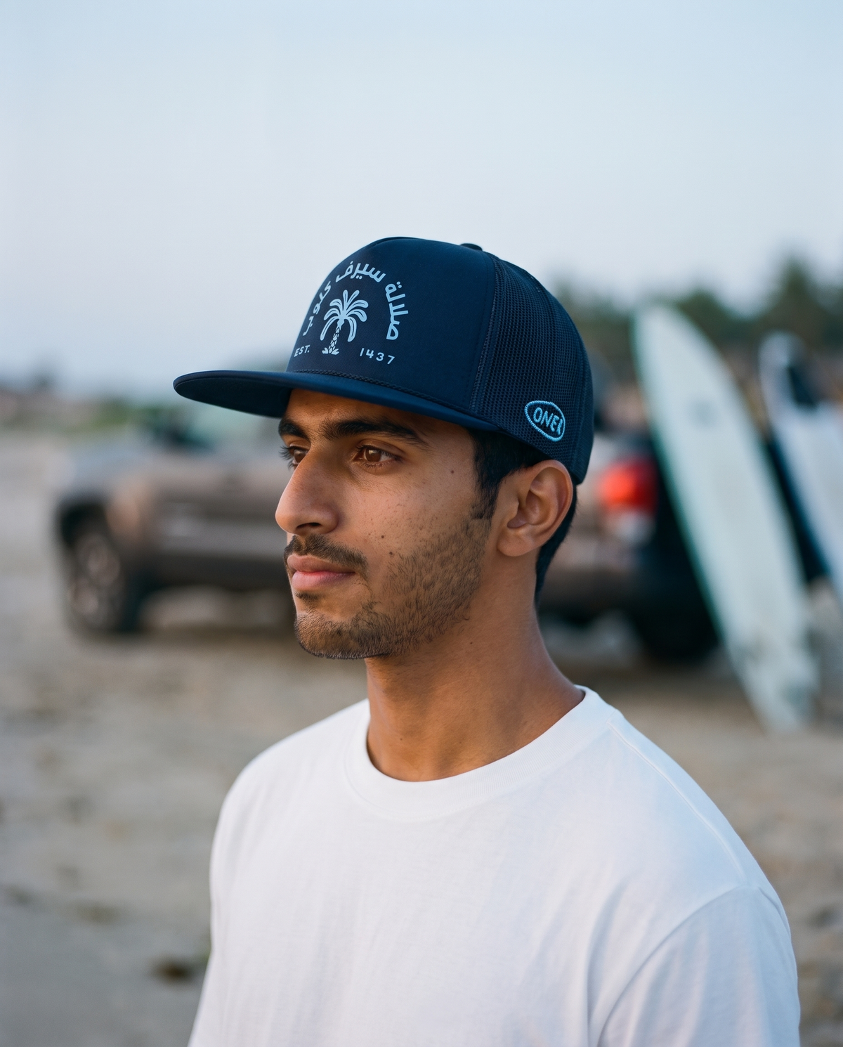 Salalah Surf Club Navy foam trucker side profile - on model